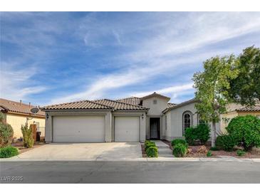 Charming single-story home with a three-car garage, desert landscaping, and a tile roof at 5903 Karnes Ranch Ave, Las Vegas, NV 89131