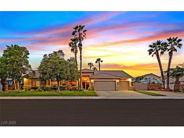 Beautiful single-story home featuring a well-manicured lawn, mature trees and a two-car garage at 6345 Cinnabar Ridge Ave, Las Vegas, NV 89130