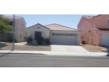 Charming single-story home featuring a tile roof, a two-car garage, and low maintenance landscaping at 857 Lantham Pl, Las Vegas, NV 89110