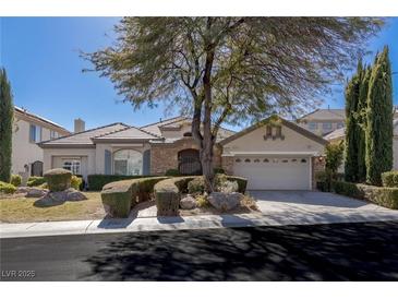 Charming single-story home with stone accents, a well-manicured yard, and a spacious two-car garage at 9421 Queen Charlotte Dr, Las Vegas, NV 89145