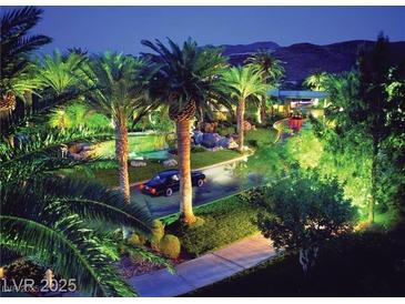 Luxurious driveway with lush landscaping, palm trees, waterfall feature, and a peek of the mountains at , Henderson, NV 89012