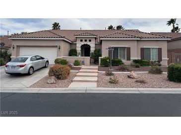 Charming single-story home featuring a well-manicured front yard and a two-car garage at 10023 Liberty View Rd, Las Vegas, NV 89148