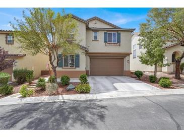 Charming two-story home with a well-manicured front yard and a two-car garage at 10631 Kennedy Peak Ln, Las Vegas, NV 89166