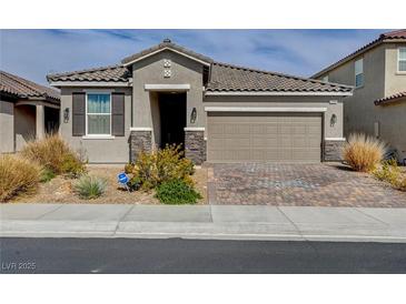 Charming single-story home with a tile roof, brick driveway, and a well-maintained front yard at 1634 Deep Valley Ave, North Las Vegas, NV 89084
