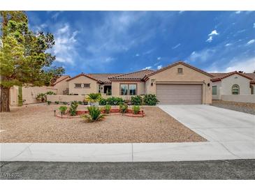 Charming single-story home features a low maintenance yard, desert landscaping, and a two car garage at 2092 Wildwood Lake Street, Henderson, NV 89052