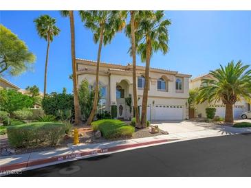 Beautiful two-story home with a well-maintained front yard and tall palm trees, creating a welcoming curb appeal at 2097 Eaglepath Cir, Henderson, NV 89074