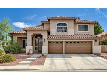Inviting two-story home featuring a tile roof, three-car garage, and manicured landscaping at 3055 Whispering Crest Dr, Henderson, NV 89052