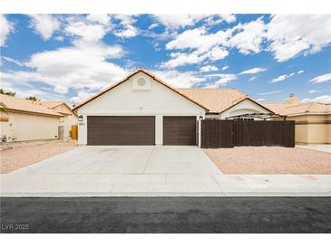 Charming single-story home featuring a two-car garage and a well-maintained front yard in a sunny neighborhood at 3630 Daisy Field Dr, North Las Vegas, NV 89032