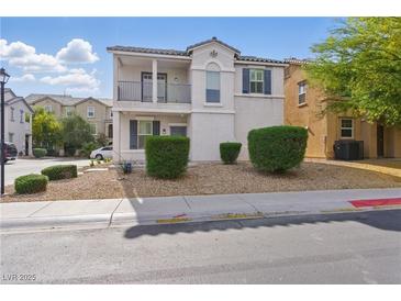 Two-story home featuring a balcony, neutral-toned exterior, manicured landscaping, and a welcoming entrance at 4517 Lime Straight Dr, Las Vegas, NV 89115