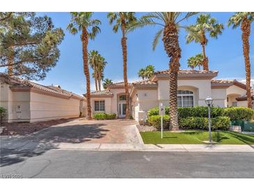 Charming single story home with well manicured lawn and lush palm trees in a desirable neighborhood at 465 Indigo Springs St, Henderson, NV 89014