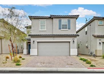 Charming two-story home featuring a two-car garage, neutral tones, and a beautifully landscaped front yard at 6130 Yuzu Pl, Las Vegas, NV 89122