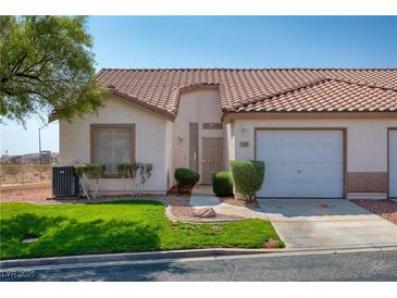 Charming single-story home featuring a tile roof, well-manicured lawn, and a one-car garage at 653 Mountain Rdg, Mesquite, NV 89027