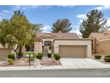 Inviting single-story home with desert landscaping, two-car garage, and tile roof at 9437 January Dr, Las Vegas, NV 89134