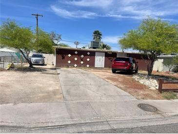 Charming single-story home with brick accents, mature trees, and a spacious driveway for multiple vehicles at , North Las Vegas, NV 89030