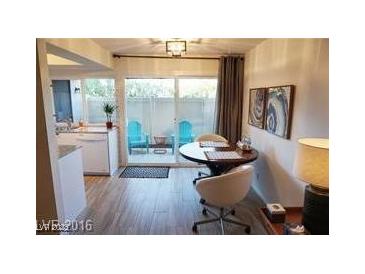 Cozy dining area featuring modern furnishings and a sliding glass door leading to a charming patio at 1370 Vegas Valley Dr # 47, Las Vegas, NV 89169
