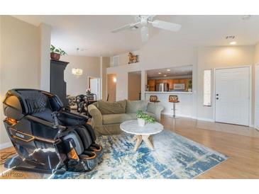 Bright living room featuring an open layout, plush seating, and modern decor and wood-look floors at 2325 Windmill Pkwy # 323, Henderson, NV 89074