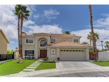 Beautiful two-story home featuring a tile roof, desert landscaping, and a two-car garage at 3005 Stern Dr, Las Vegas, NV 89117