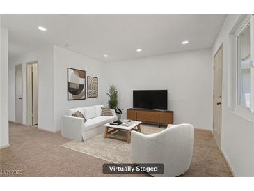 Staged living room featuring neutral tones, plush seating, and contemporary decor at 304 Orland St # 47, Las Vegas, NV 89107