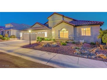 Charming single-Gathering home featuring a three-car garage and desert landscaping at 3091 Via Del Corso, Henderson, NV 89052