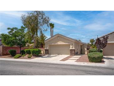 Charming single-story home featuring desert landscaping and a two-car garage at 4140 Gliding Gulls Ave, North Las Vegas, NV 89084