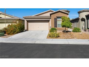 Charming single-story home featuring a two-car garage and nicely landscaped front yard at 5521 Moss Landing St, North Las Vegas, NV 89031
