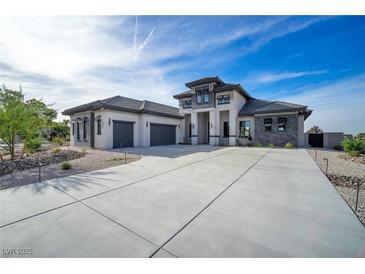 Stunning two-story modern home featuring a spacious driveway, multi-car garage, and manicured landscaping at 600 Quail Covey Road, Henderson, NV 89002