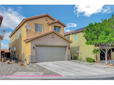 Inviting home featuring a two-car garage and landscaped front yard, creating a welcoming curb appeal at 722 Chepstow Ave, Las Vegas, NV 89178