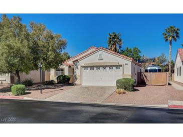 Charming single-story home featuring desert landscaping, a two-car garage, and a tile roof at 8041 Villa Rosarito St, Las Vegas, NV 89131