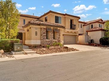 Charming two-story home with a stone facade and a well-manicured front yard at 8267 Campbell Springs Ave, Las Vegas, NV 89178