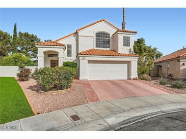 Charming two-story home featuring a white stucco facade, clay tile roof, and well-maintained landscaping at 9921 Heffner Hills Cir, Las Vegas, NV 89117