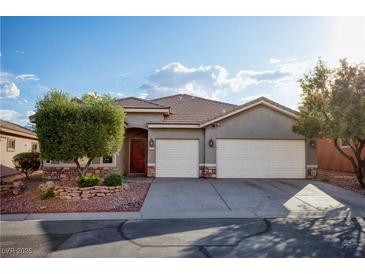 Charming single-story home featuring a three-car garage and beautifully landscaped front yard at 1153 Mesa Verde Run, Mesquite, NV 89027
