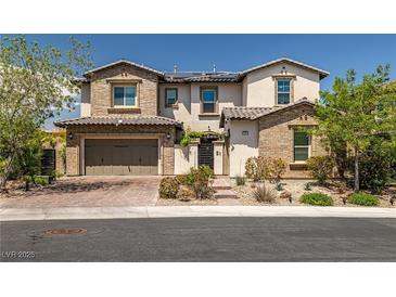 Charming two-story home with brick accents, a two-car garage, and beautifully landscaped front yard at 12024 Girasole Ave, Las Vegas, NV 89138