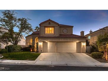 Charming two-story home featuring a three-car garage and well-maintained landscaping at 13 Cozy Glen Cir, Henderson, NV 89074