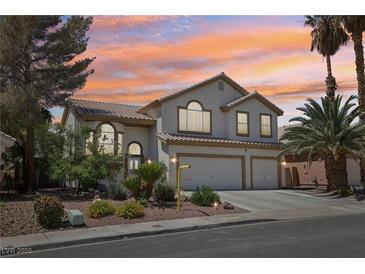 Charming two-story home with a three-car garage, desert landscaping, and beautiful desert sunset at 1707 Navarre Ln, Henderson, NV 89014
