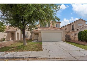 Charming two-story home featuring a two-car garage and a well-maintained front yard with mature landscaping at 1909 Falling Tree Ave, North Las Vegas, NV 89031