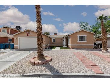 Charming single-story home with well-maintained landscaping, complemented by mature trees at 1911 Venalynne St, Las Vegas, NV 89156