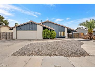 Inviting home exterior featuring desert landscaping, a two-car garage, and a charming facade at 5120 Burnham Ave, Las Vegas, NV 89119