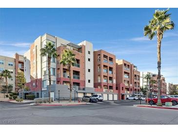 Attractive multi-story condominium building with palm trees and well-maintained landscaping at 59 E Agate Ave # 406, Las Vegas, NV 89123