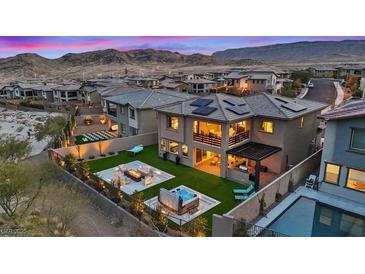 Stunning backyard with a fire pit, hot tub, modern patio, and ample outdoor seating at 754 Spirit Lake St, Las Vegas, NV 89138