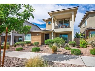 Beautiful two-story home with a balcony, desert landscaping, and a well-maintained front yard at 1000 E Sunset Rd, Henderson, NV 89011