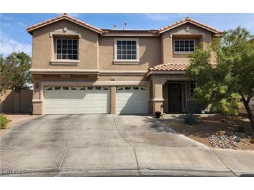 Charming two-story home features a well-maintained front yard, a tile roof, and a convenient two-car garage at 1048 Painted Daisy Ave, Henderson, NV 89074