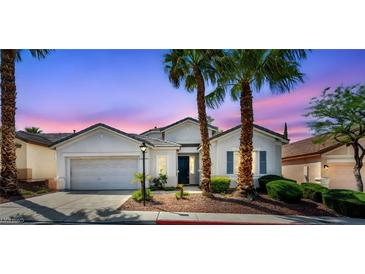 Charming single story home with palm trees and a well-manicured front yard at 129 Sapodilla Ln, Las Vegas, NV 89144