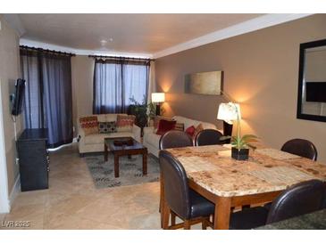 Comfortable living space with dining area, plush seating, and neutral decor at 220 E Flamingo Rd # 104, Las Vegas, NV 89169