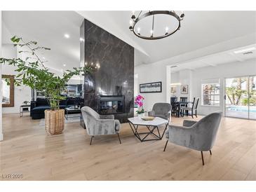 Bright living room featuring hardwood floors, fireplace, and modern gray furniture set at 2337 Prometheus Ct, Henderson, NV 89074