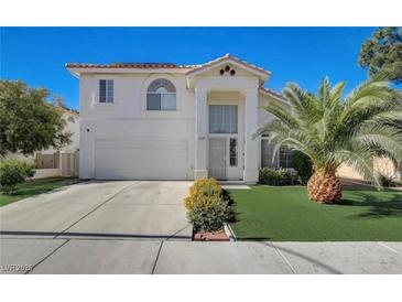 Two-story home featuring an attached garage, well-kept lawn, and lovely curb appeal at 2714 Cricket Hollow Ct, Henderson, NV 89074