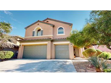 Inviting two-story home boasts a three-car garage, desert landscaping, and a charming terracotta roof at 3425 Fledgling Dr, North Las Vegas, NV 89084