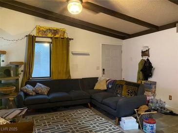 Comfortable living room features a large gray sectional sofa and a decorative rug at 4748 Obannon Dr # C, Las Vegas, NV 89102