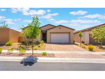 Charming single-story home featuring a well-manicured front yard and brick paver driveway at 715 Drammatico Pl, Henderson, NV 89011