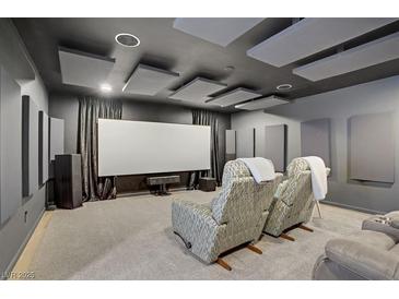 Relax in this modern theater room with comfortable seating and an impressive entertainment setup at 8016 Carpenter Creek Ave, Las Vegas, NV 89113