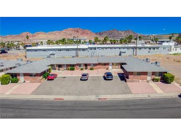 Low-rise apartment complex featuring brick facade, individual entrances, and ample parking at 820 A Ave, Boulder City, NV 89005